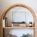 Crosley Miles Record Player - Walnut is elegantly displayed on a wooden shelf, surrounded by books and decor