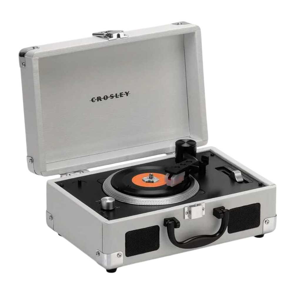 Crosley Mini Cruiser Turntable - White Sand with an orange-centered vinyl spinning on its sleek black turntable surface