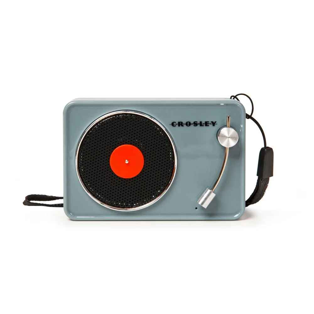 Crosley Mini Turntable Bluetooth Speaker - Tourmaline features a compact rectangular design with a mini turntable-inspired speaker grill on the front