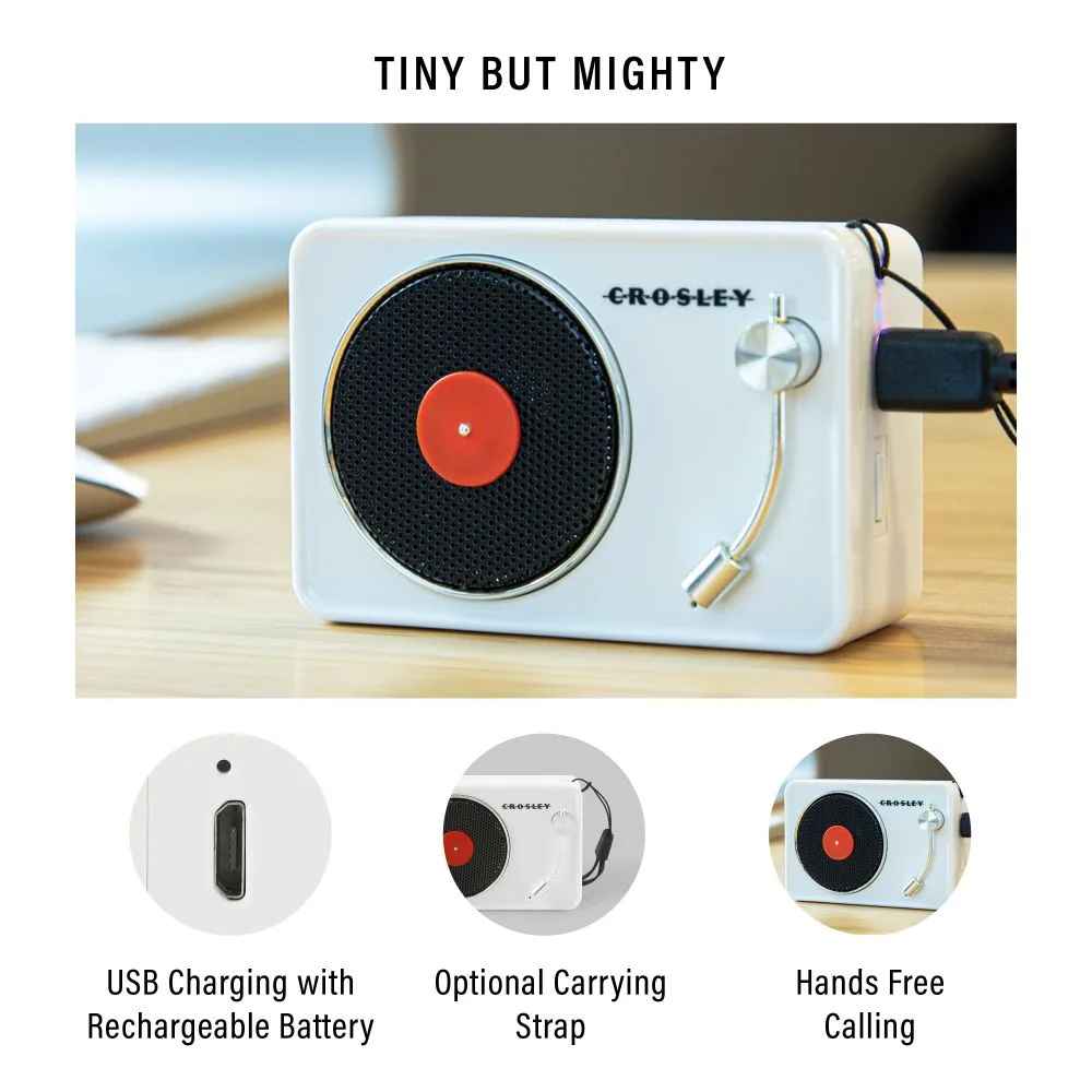 Crosley Mini Turntable Bluetooth Speaker - White is shown up close on a wooden desk with a modern retro design