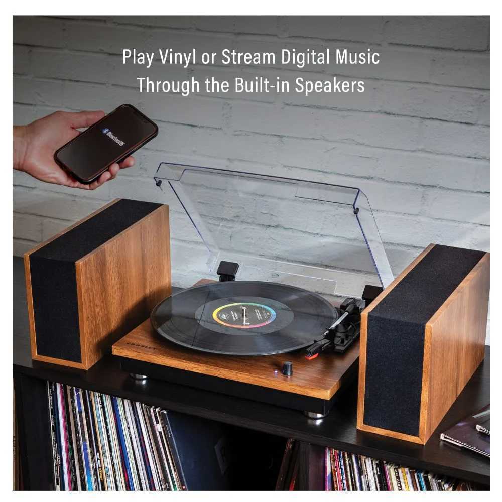 Crosley Riff Record Player With Speakers - Walnut demonstrates its ability to play vinyl records and stream music from a phone via the built-in speakers