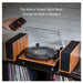 Crosley Riff Record Player With Speakers - Walnut demonstrates its ability to play vinyl records and stream music from a phone via the built-in speakers