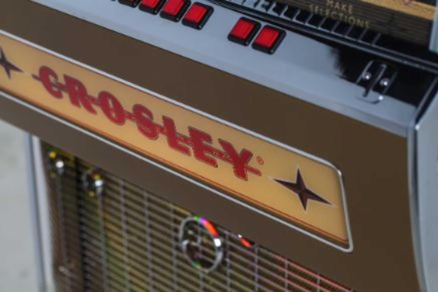 Crosley Rocket 80 CD Bluetooth Full-Size Jukebox - Black's metallic front panel with gleaming red selection buttons