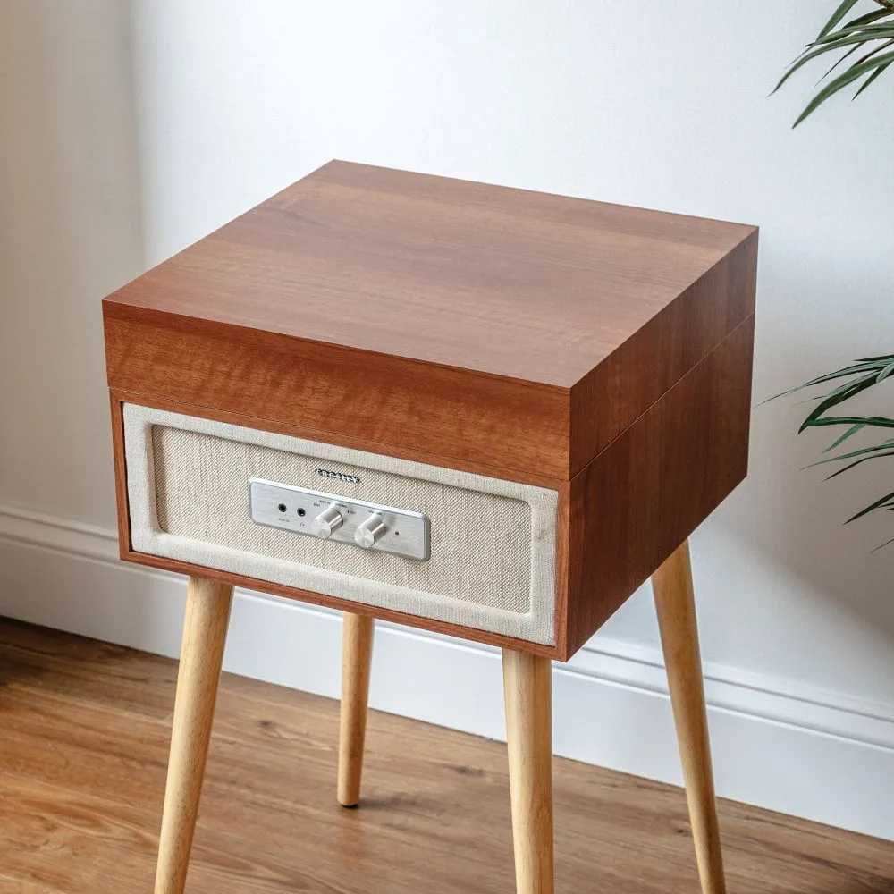 Crosley Rohe Turntable - Natural is displayed with the lid closed, highlighting its sleek wooden exterior and sturdy removable legs