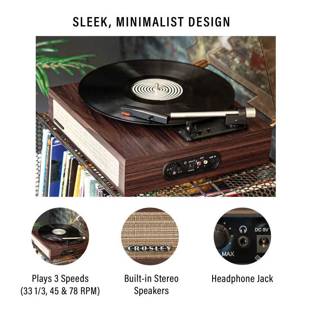 Crosley Scout Turntable - Walnut is a sleek, minimalist record player with a woodgrain finish, a vinyl disc on the platter, and built-in stereo speakers