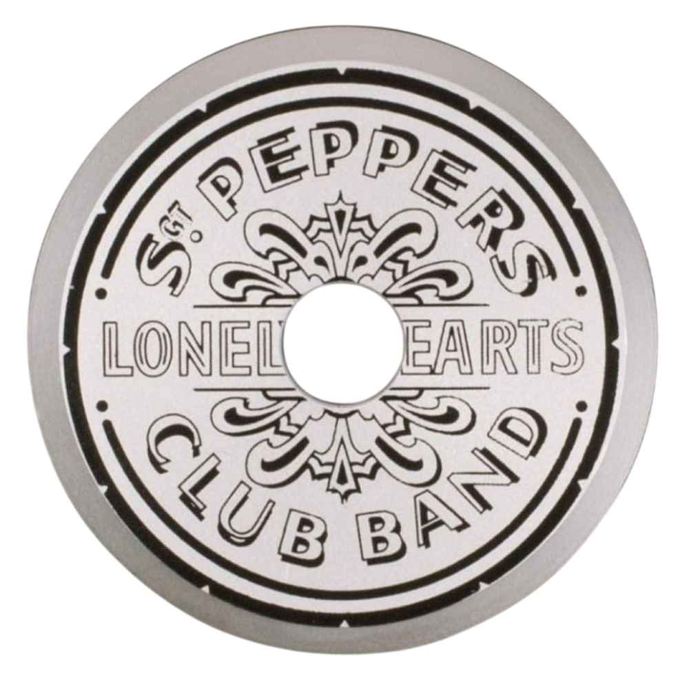 Crosley The BEATLES 45 Adapter - Sgt. Pepper, a silver circular adapter with intricate engraved text and design