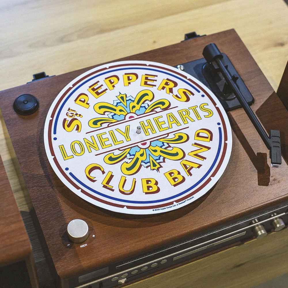 Crosley The BEATLES Platter Pad - Sgt. Pepper placed on a wooden turntable