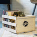 Crosley Tool-less Assembly Record Storage Crate - Natural holding a collection of vinyl records on a textured rug