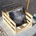 Crosley Vinyl Record Storage Crate - Natural is shown filled with colorful vinyl records in a minimal, open design on a concrete floor