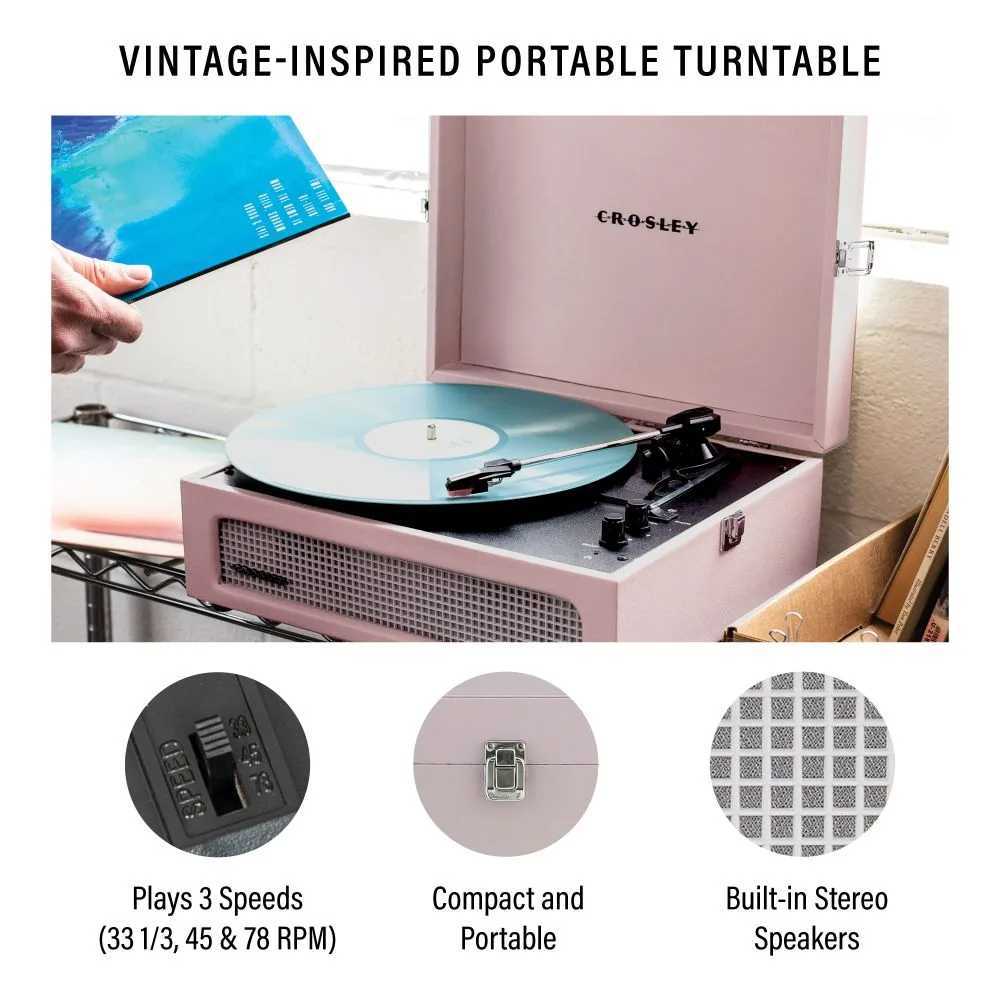 Crosley Voyager Portable Turntable with Bluetooth InOut - Amethyst is shown playing a vinyl record, highlighting its compact and vintage-inspired design with built-in stereo speakers