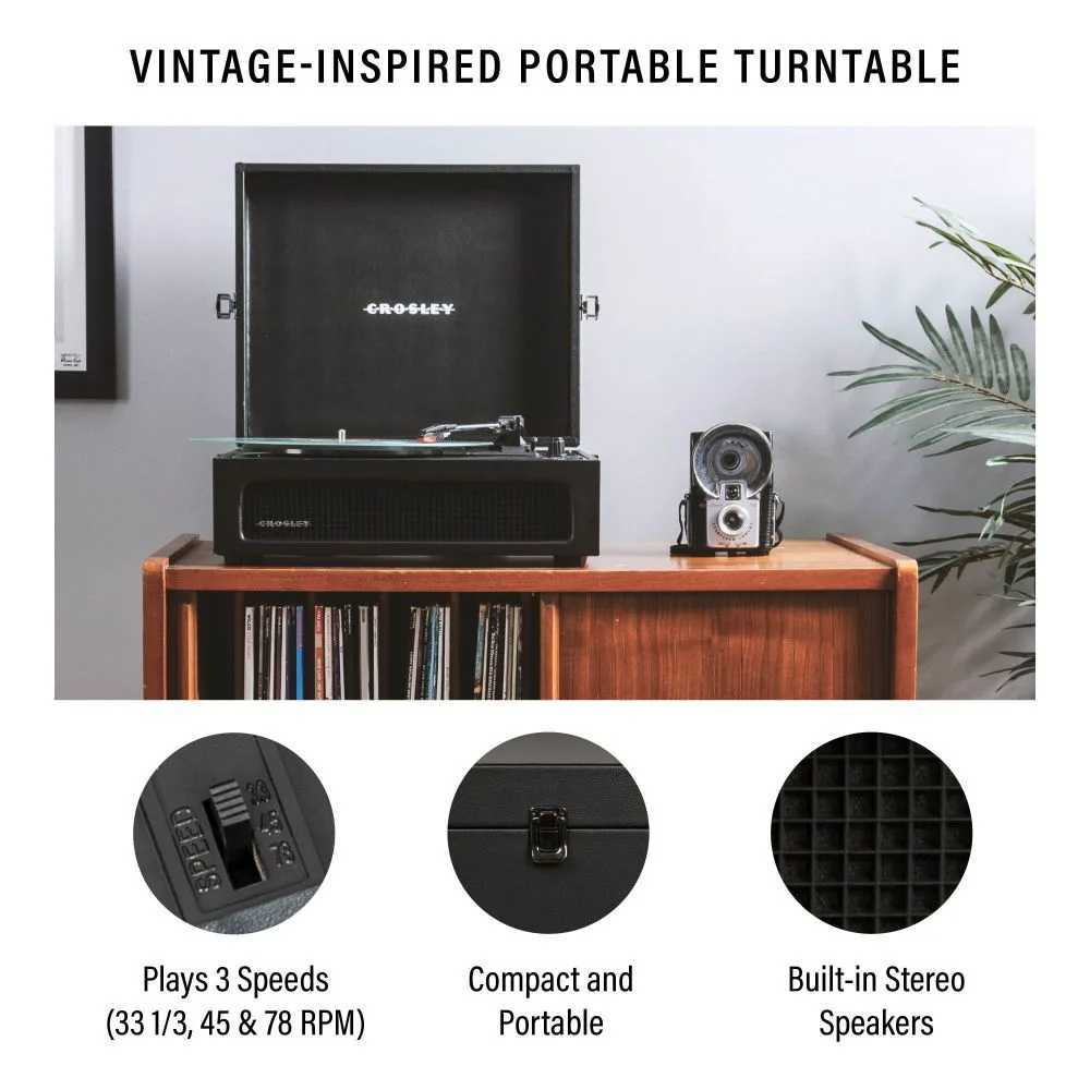 Crosley Voyager Portable Turntable with Bluetooth Out - Black is shown open, playing a record, placed stylishly on a wooden shelf with stereo speakers built-in