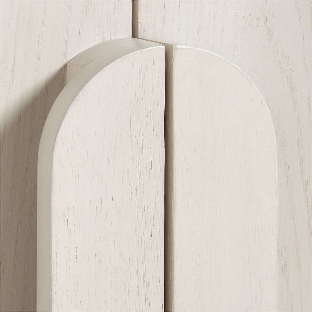 Curved wood handles on Crate & Barrel Annie 38" Whitewashed Wood Storage Bookcase with Shelves highlighting its modern design