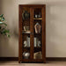 Decorative display inside Crate & Barrel Morris 36" Chocolate Brown Wood and Glass Bookcase Cabinet with books and pottery