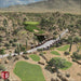 Desert-style virtual course with sand and cacti is shown using TruGolf LaunchBox Golf Launch Monitor w/ E6 CONNECT Home + Premium
