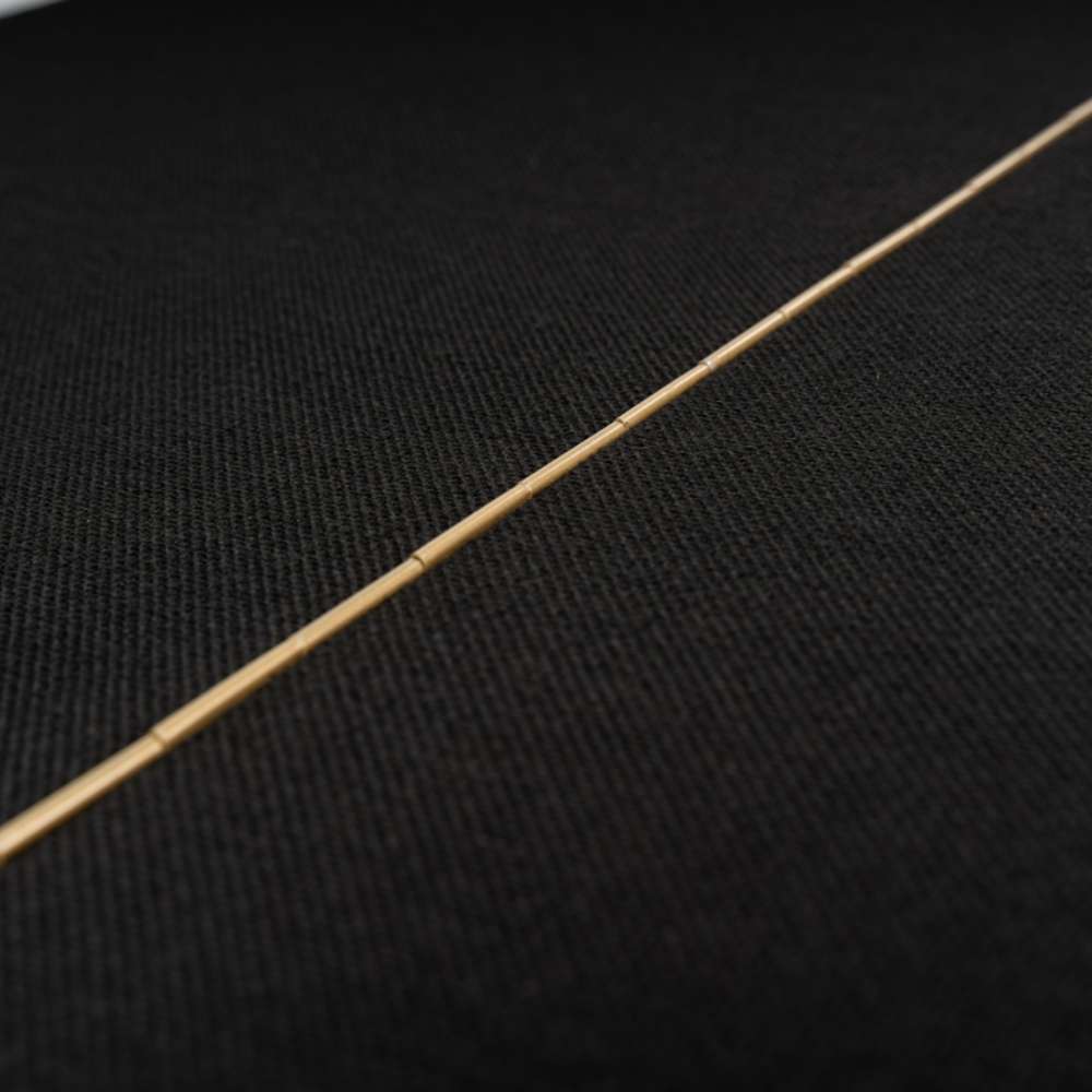 Detailed close-up of the brass hinge running across the black fabric-covered panels of GIK Acoustics ScreenPanel Vocal Screen