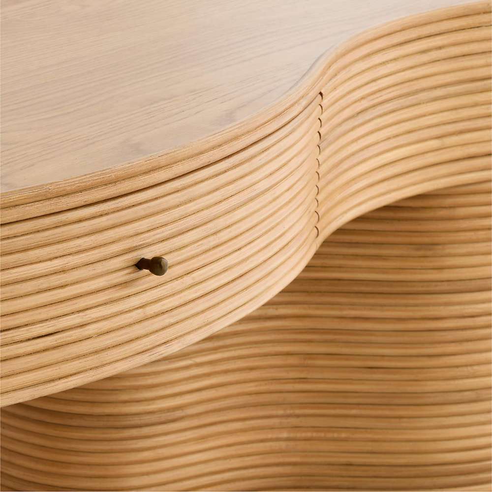 Detailed view of the sculpted wood grain, rounded edges, and hidden drawer pull on Crate & Barrel Delphine 73" Storage Console Table Desk