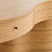 Detailed view of the sculpted wood grain, rounded edges, and hidden drawer pull on Crate & Barrel Delphine 73" Storage Console Table Desk