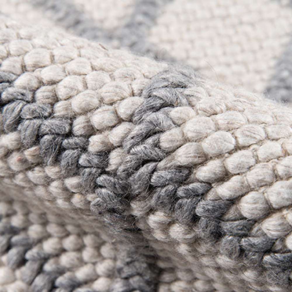 Detailed fabric fold of Momeni Andes Indoor Rug - AND-7 Natural displays its thick, soft wool construction and intricate diamond design