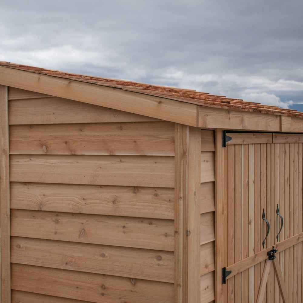 Double Door Cedar Roof Outdoor Living Today 8×4 SpaceSaver Lean-To Cedar Shed highlights the slanted cedar roofline and detailed side paneling in a close-up view
