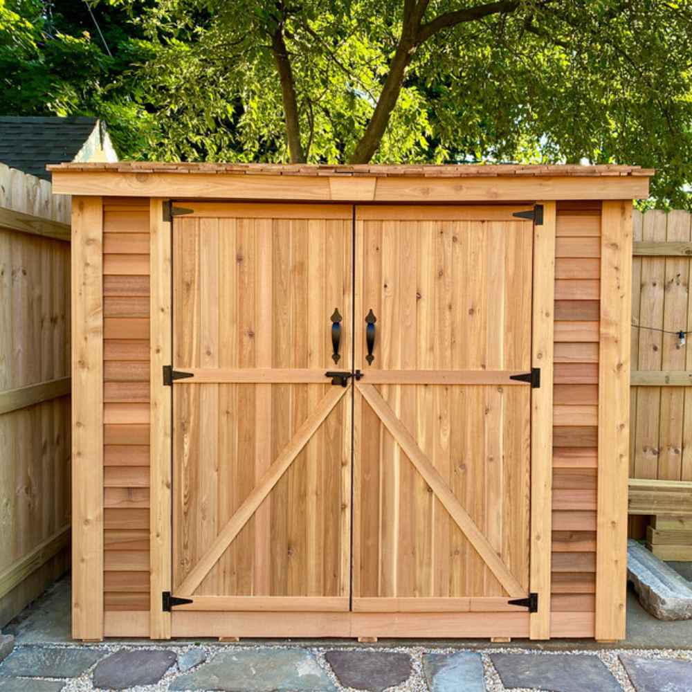 Double Door Cedar Roof Outdoor Living Today 8×4 SpaceSaver Lean-To Cedar Shed is placed in a backyard with a tree overhead and its wide cedar doors shut
