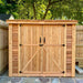 Double Door Cedar Roof Outdoor Living Today 8×4 SpaceSaver Lean-To Cedar Shed is placed in a backyard with a tree overhead and its wide cedar doors shut