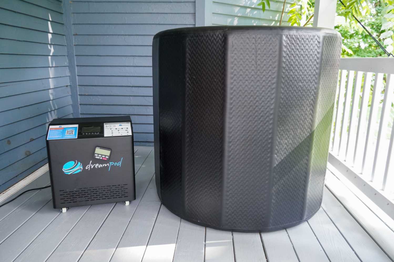 Dreampod Cold Plunge Barrel FLEX with Chiller along with its accompanying control unit, placed on a porch