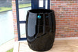 Dreampod Cold Plunge Barrel with Chiller in a glossy black finish is displayed by a bright window