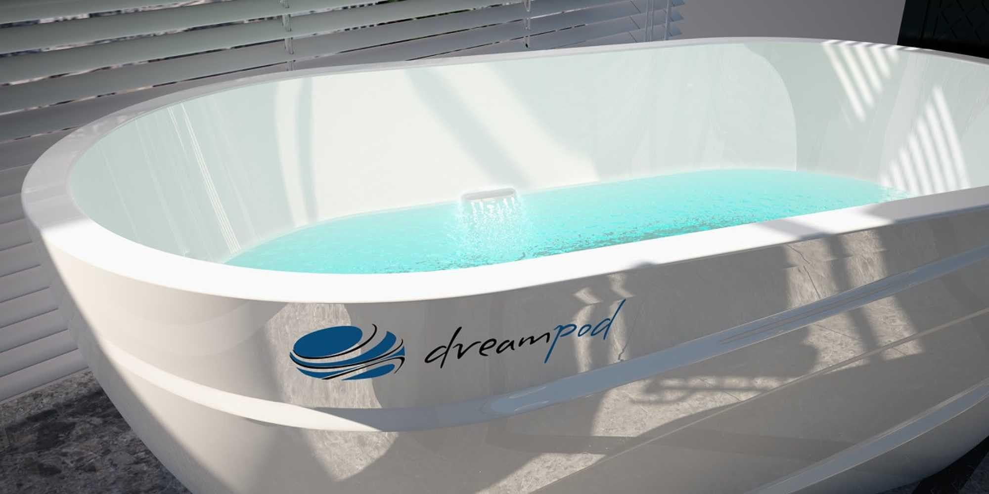 Dreampod Mineral Soaker is a sleek, oval-shaped white tank filled with calm, light-blue water