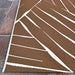 Edge view of Couristan Dolce Indoor/Outdoor Rug - Parquet/Amber highlights a bold ivory zigzag pattern on an amber background