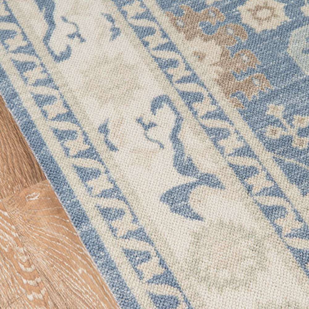 Edge view of Momeni Anatolia Indoor Rug - ANA-7 Light Blue highlights the light border with soft blue decorative accents