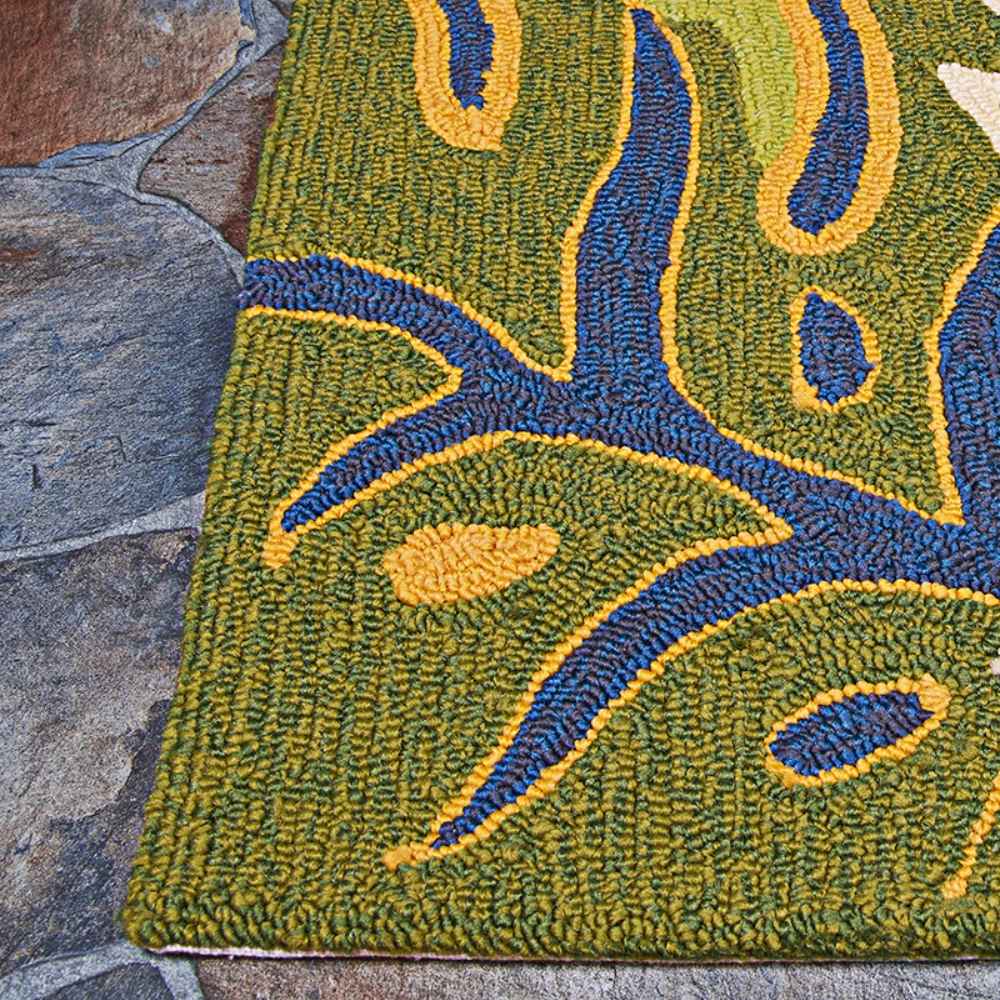Edge of the Couristan Covington Indoor/Outdoor Rug - Areca Palms/Brown-Forest Green shows green and navy leaf motifs woven into a detailed, textured surface