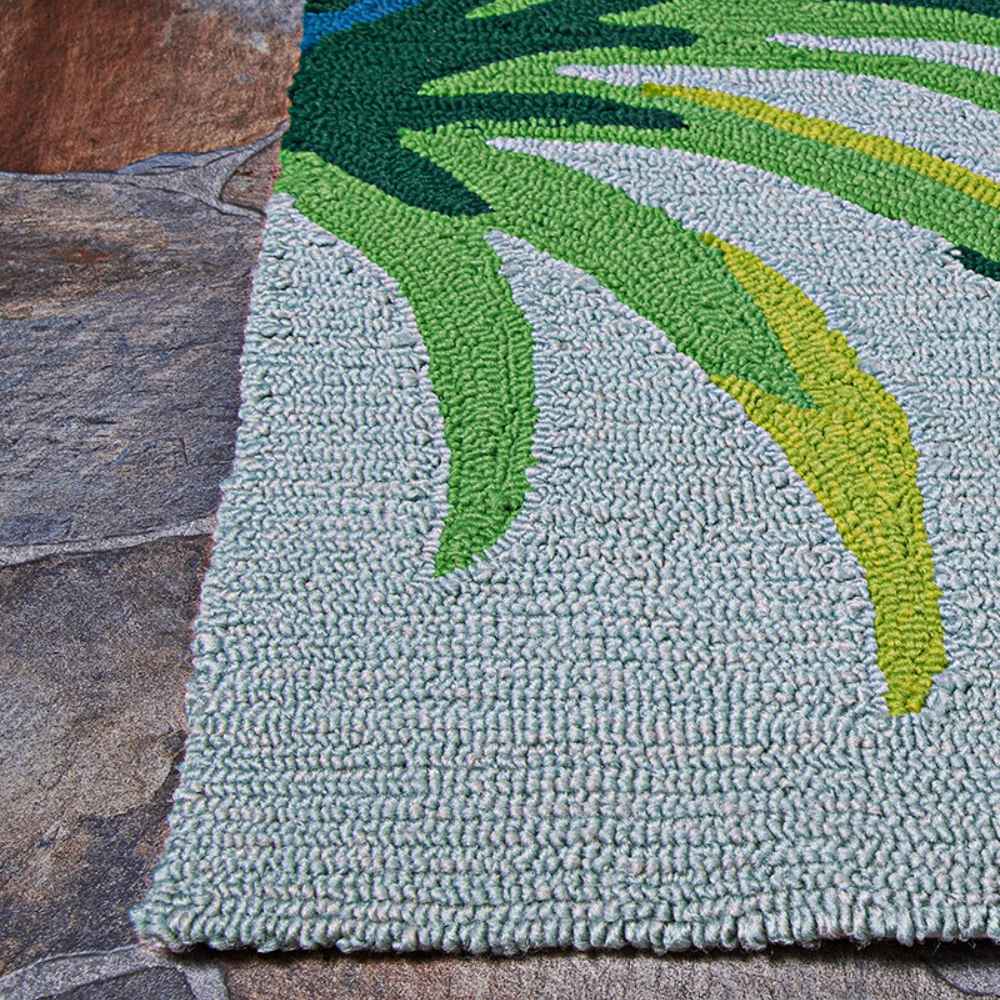 Edge of the Couristan Covington Indoor/Outdoor Rug - Flamingos/Multi lies neatly on stone flooring