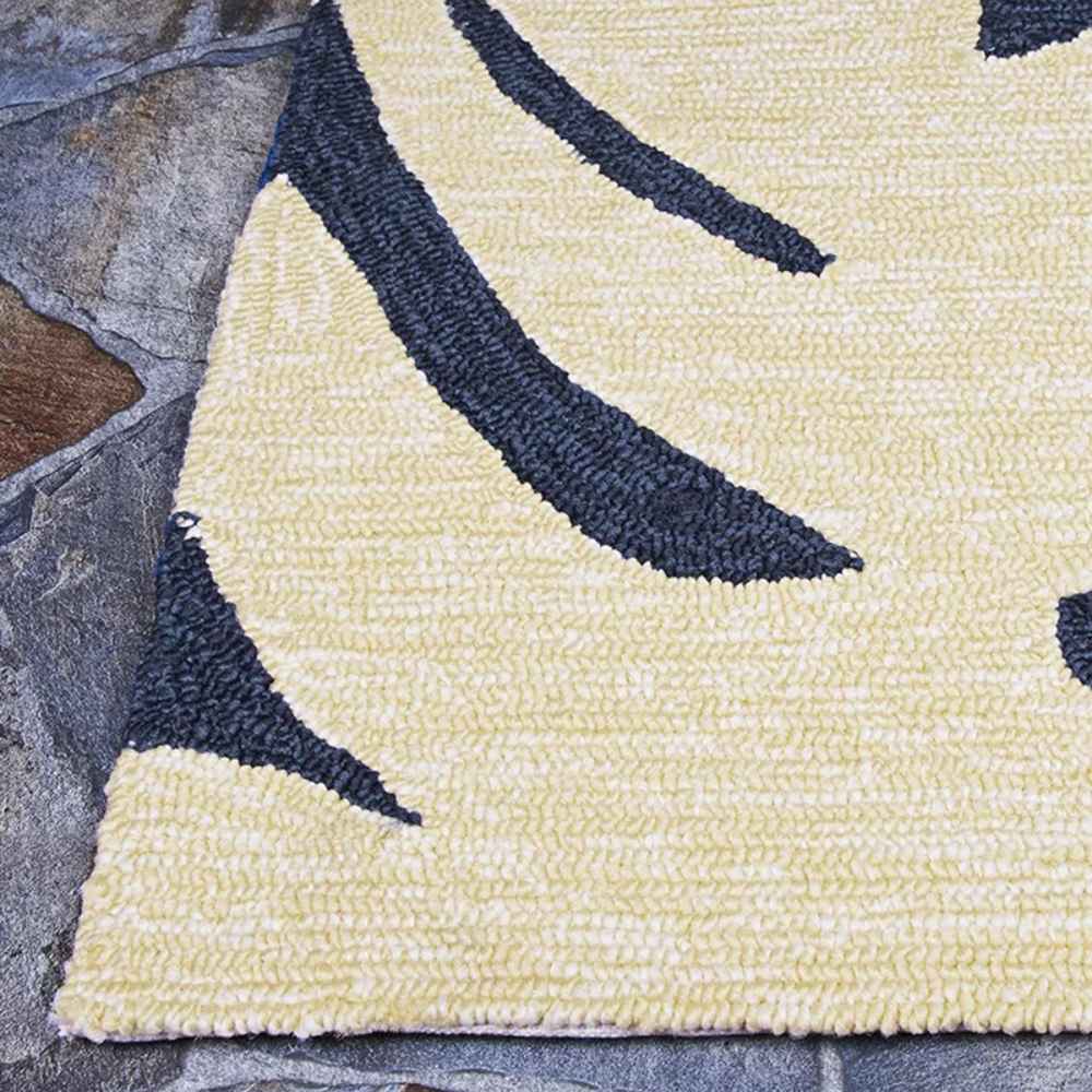 Edge of the Couristan Covington Indoor/Outdoor Rug - Palms/Navy highlights the thick, looped texture and dark palm fronds