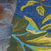 Edge of the Couristan Covington Indoor/Outdoor Rug - Tropical Orchid/Azure-Forest Green-Red rests on stone flooring