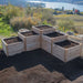 Empty tiered wooden planter filled with soil sits outdoors, showcasing the Outdoor Living Today 5.5×2 Tiered Cedar L-Shaped Raised Garden Bed in the middle
