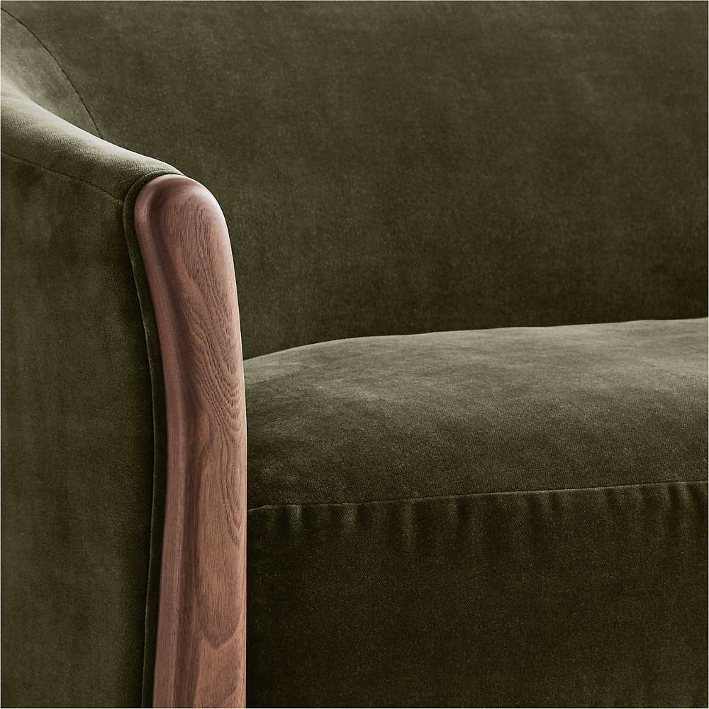 Fabric Olive (Como Velvet) Crate & Barrel Contour Sofa close-up showing the soft olive velvet seat and curved walnut wood arm detail