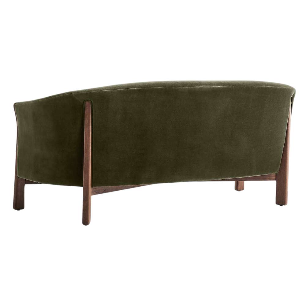 Fabric Olive (Como Velvet) Crate & Barrel Contour Sofa shown from the back, highlighting its curved olive velvet upholstery and exposed walnut wood frame