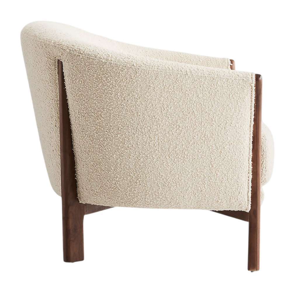 Fabric Tapioca (Lucie Boucle) Crate & Barrel Contour Sofa side view highlighting its curved cream boucle back and solid walnut wood frame