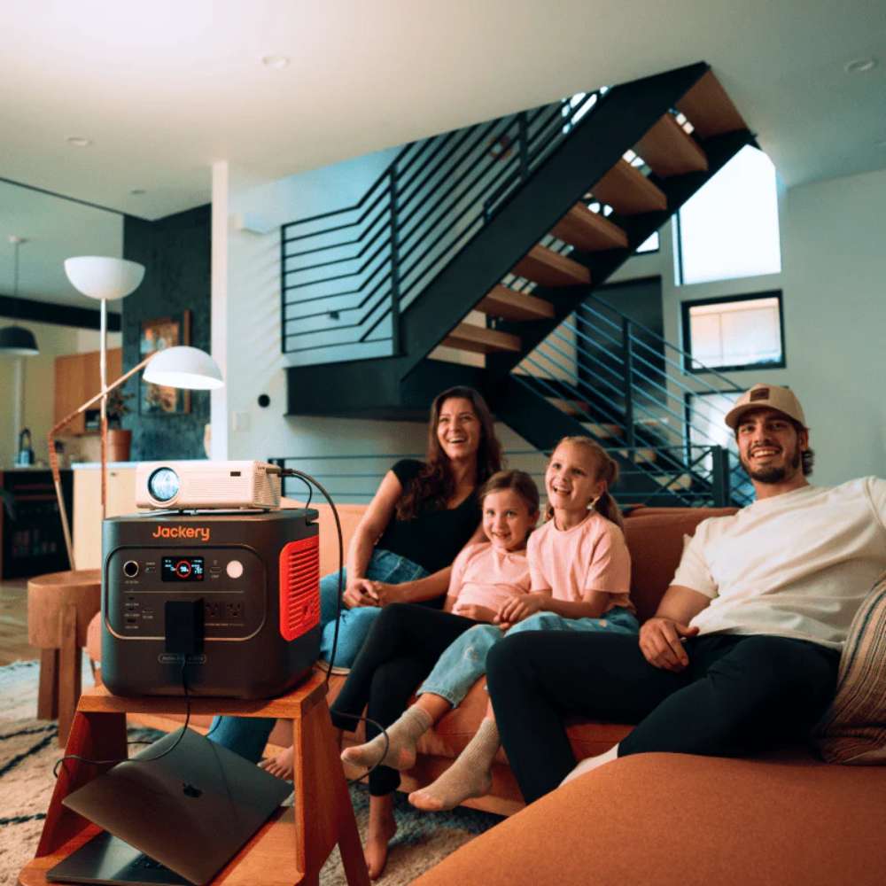 Family watches a projector powered by Jackery Explorer 2000 V2 Portable Power Station, demonstrating portable backup power for home entertainment