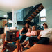 Family watches a projector powered by Jackery Explorer 2000 V2 Portable Power Station, demonstrating portable backup power for home entertainment