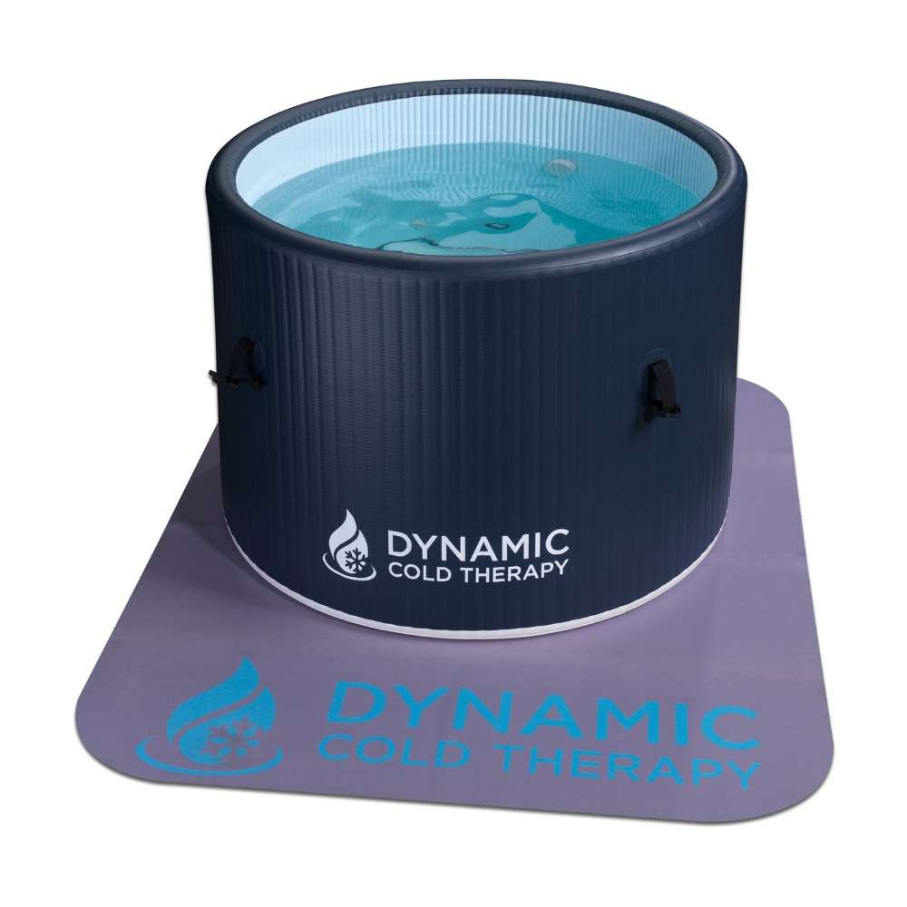 Filled with clear blue water, Golden Designs Dynamic Cold Therapy Inflatable Round Cold Plunge stands on a lavender floor mat printed with the Dynamic Cold Therapy logo