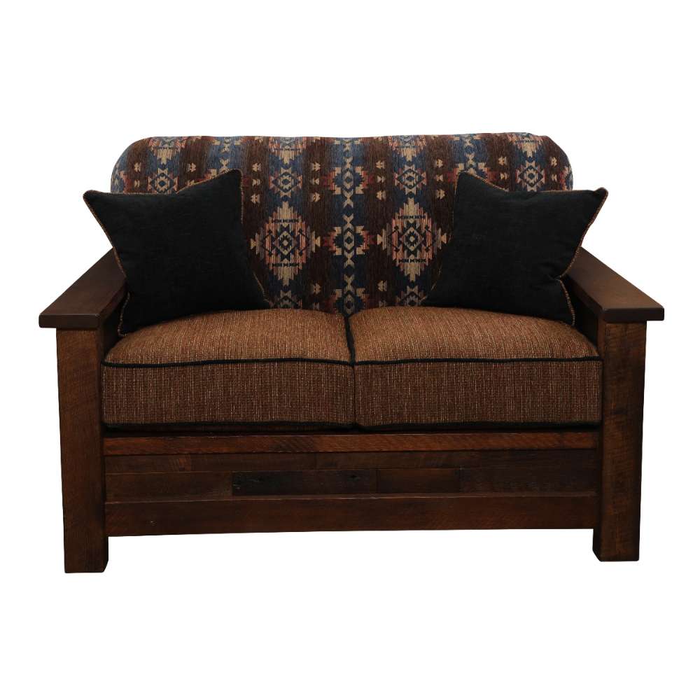 Fireside Lodge Barnwood Americana Loveseat from the front with two dark throw pillows resting against its Southwestern-style backrest