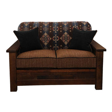 Fireside Lodge Barnwood Americana Loveseat from the front with two dark throw pillows resting against its Southwestern-style backrest