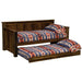 Fireside Lodge Barnwood Daybed With Roll Out Trundle shows both mattresses made up with patterned bedding and the trundle pulled out