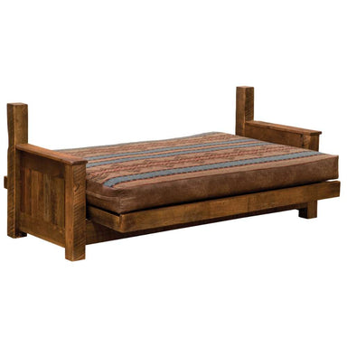 Fireside Lodge Barnwood Futon with 8" Mattress fully extended into a flat bed, revealing its thick, patterned mattress resting on a solid reclaimed-wood frame
