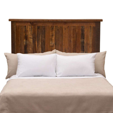 Fireside Lodge Barnwood Traditional Headboard shown as a tall, solid wood headboard with vertical reclaimed barnwood planks in a warm brown finish behind a neatly made bed