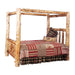 Fireside Lodge Cedar Log Canopy Bed shown as a rustic log canopy bed made from thick cedar logs with visible knots, topped with a patchwork quilt and pillows