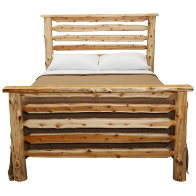 Fireside Lodge Cedar Log Headwaters Bed is shown straight on with white pillows and a neutral blanket, emphasizing the rustic log headboard and footboard design