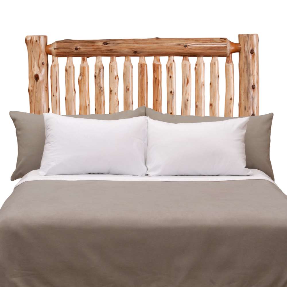 Fireside Lodge Cedar Log Small Spindle Headboard shown fully assembled on a bed, featuring rustic cedar logs, vertical spindles, and a natural lodge-style design