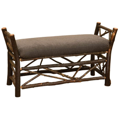 Fireside Lodge Hickory Log Bedside Bench with Twig Accent is a rustic hickory log bench with twig detailing and a cushioned brown seat